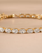 Gold oval diamond vintage bracelet laying on a neutral background