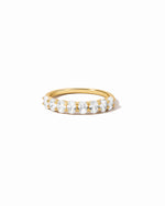Gold ring with oval gemstones on a white background