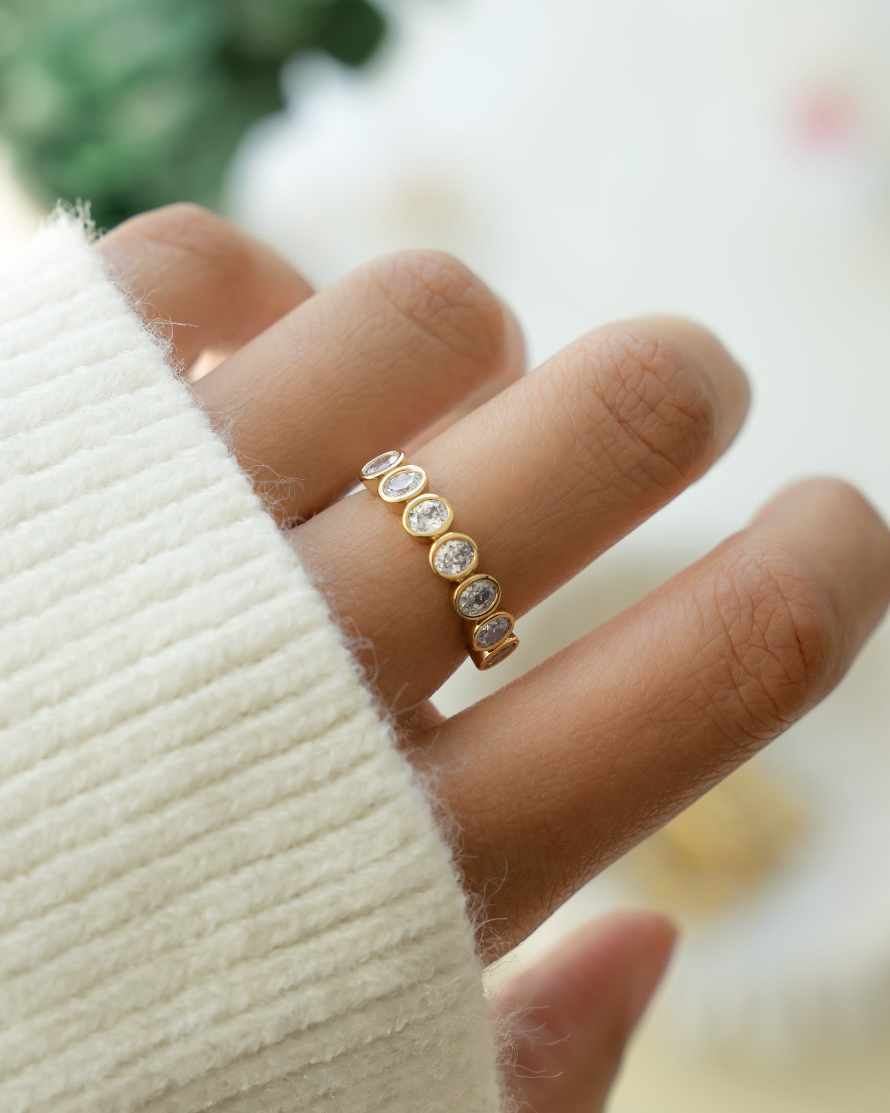 Gold bezel set diamond ring on model