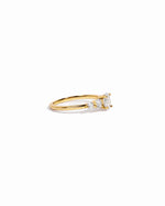 Side view of gold diamond ring on a white background 