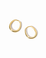 Gold hoop earrings on a white background