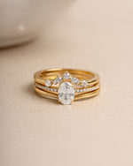 Gold diamond ring set on a beige background