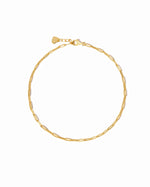 Gold paperclip chain anklet on a white background 