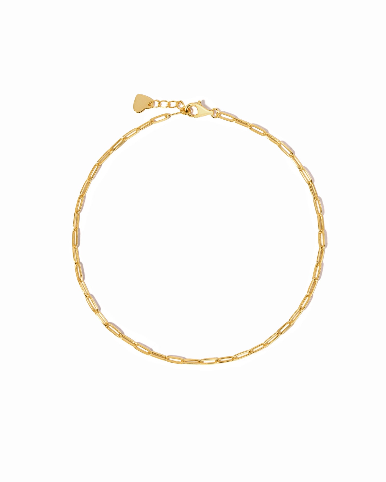 Gold paperclip chain anklet on a white background 