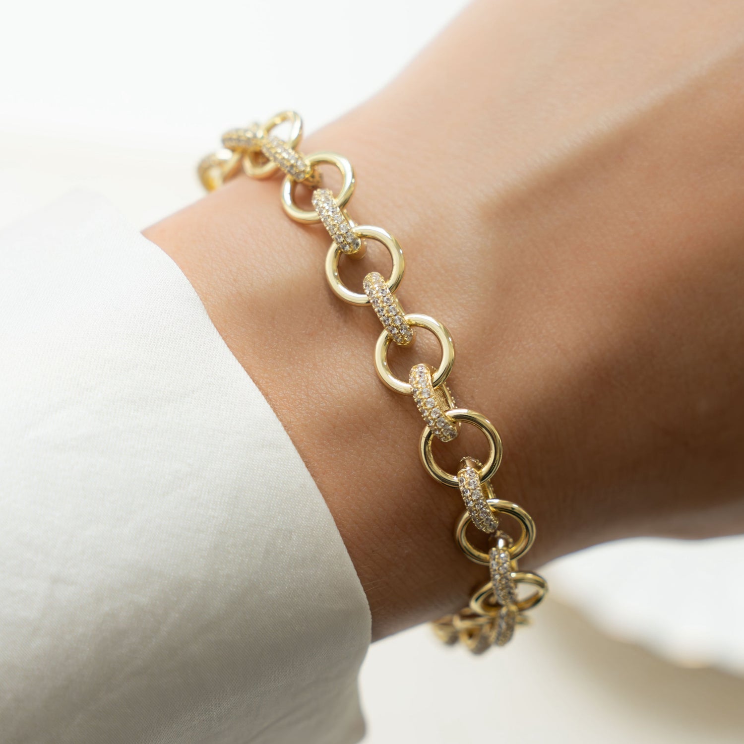 Model wearing gold chain bracelet with cubic zirconia diamonds 
