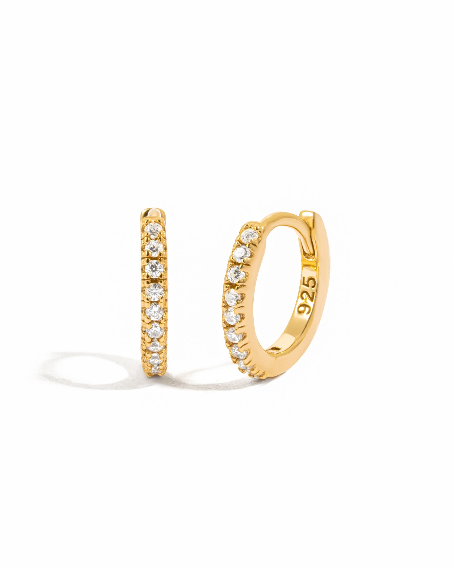 Dainty gold pavé huggies.