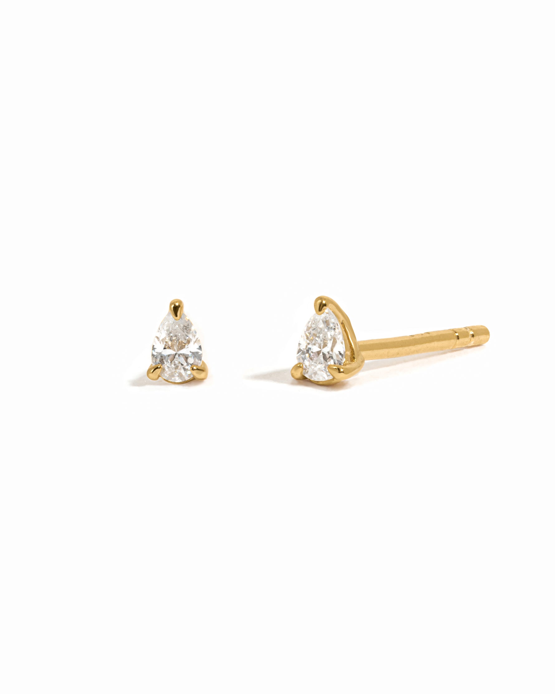 Gold stud earrings on a white background 