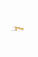 closeup image of gold baguette ring with freshwater pearl