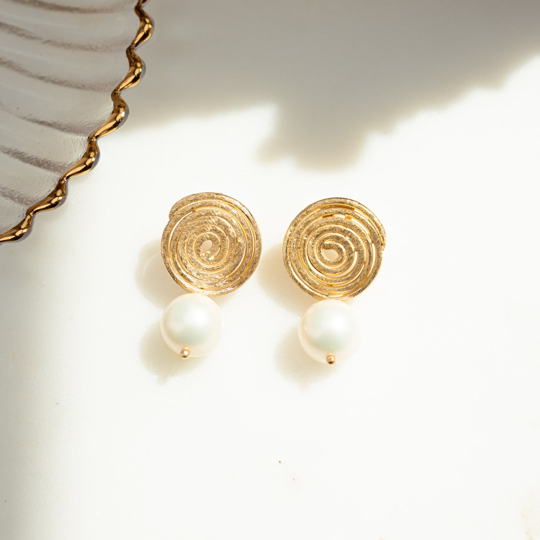 close-up image of boho earrings featuring spiral earring design