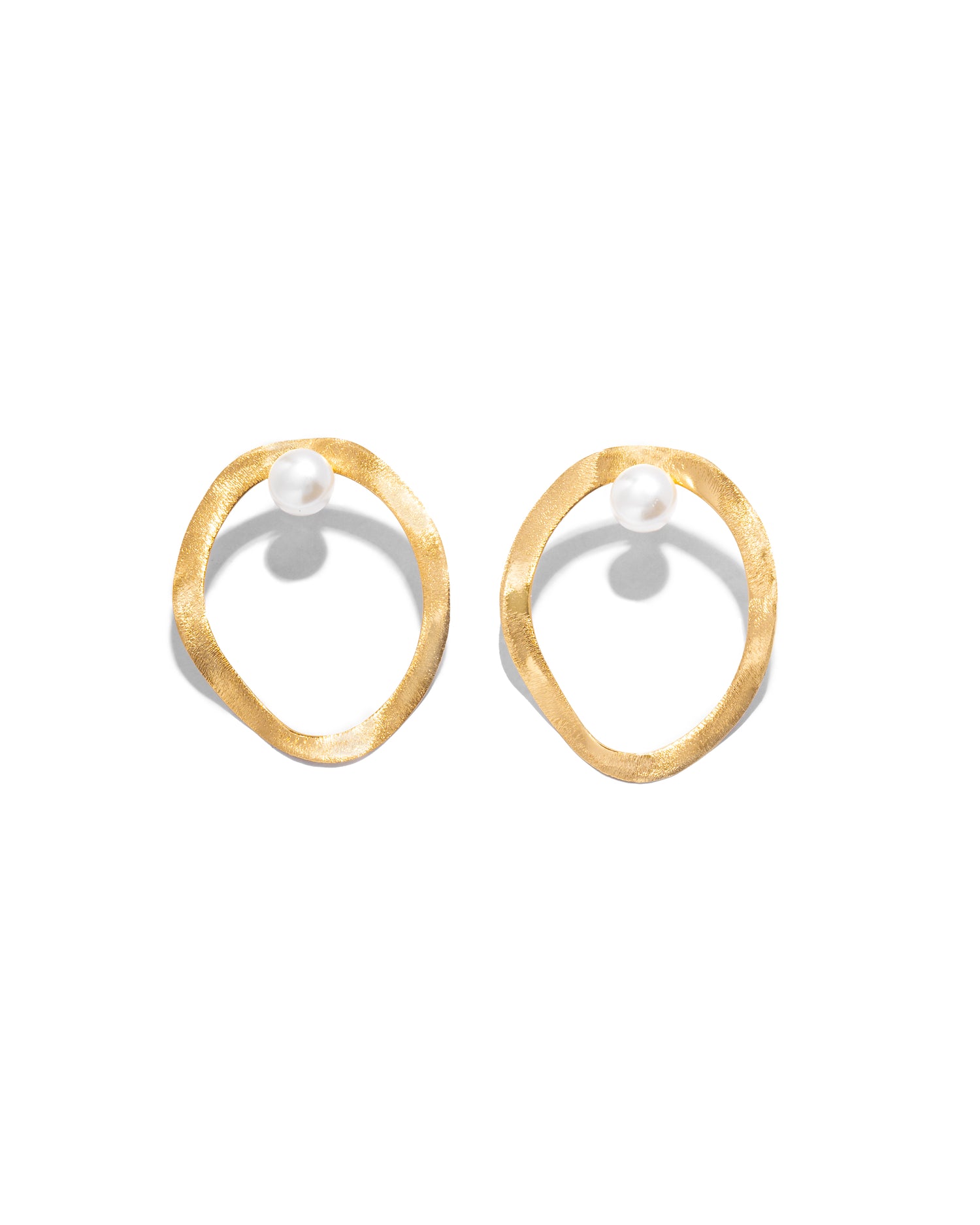 closeup image of gold organic shape unique earrings
