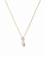 Gold necklace with a single pearl pendant on a white background