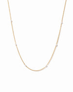 Gold beaded pearl necklace on white background 