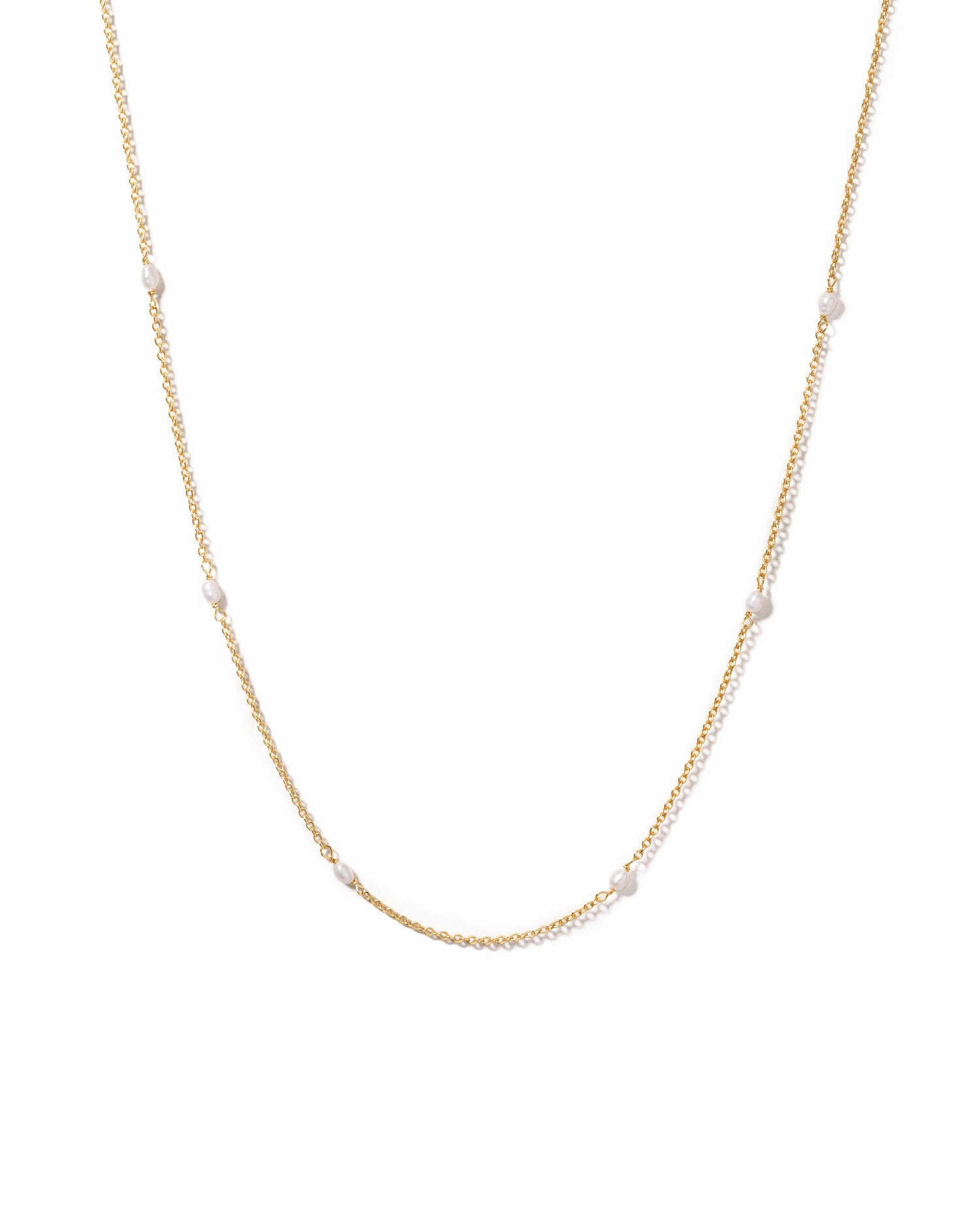 Gold beaded pearl necklace on white background 