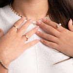 Model wearing gold stackable rings featuring a gold pearl ring