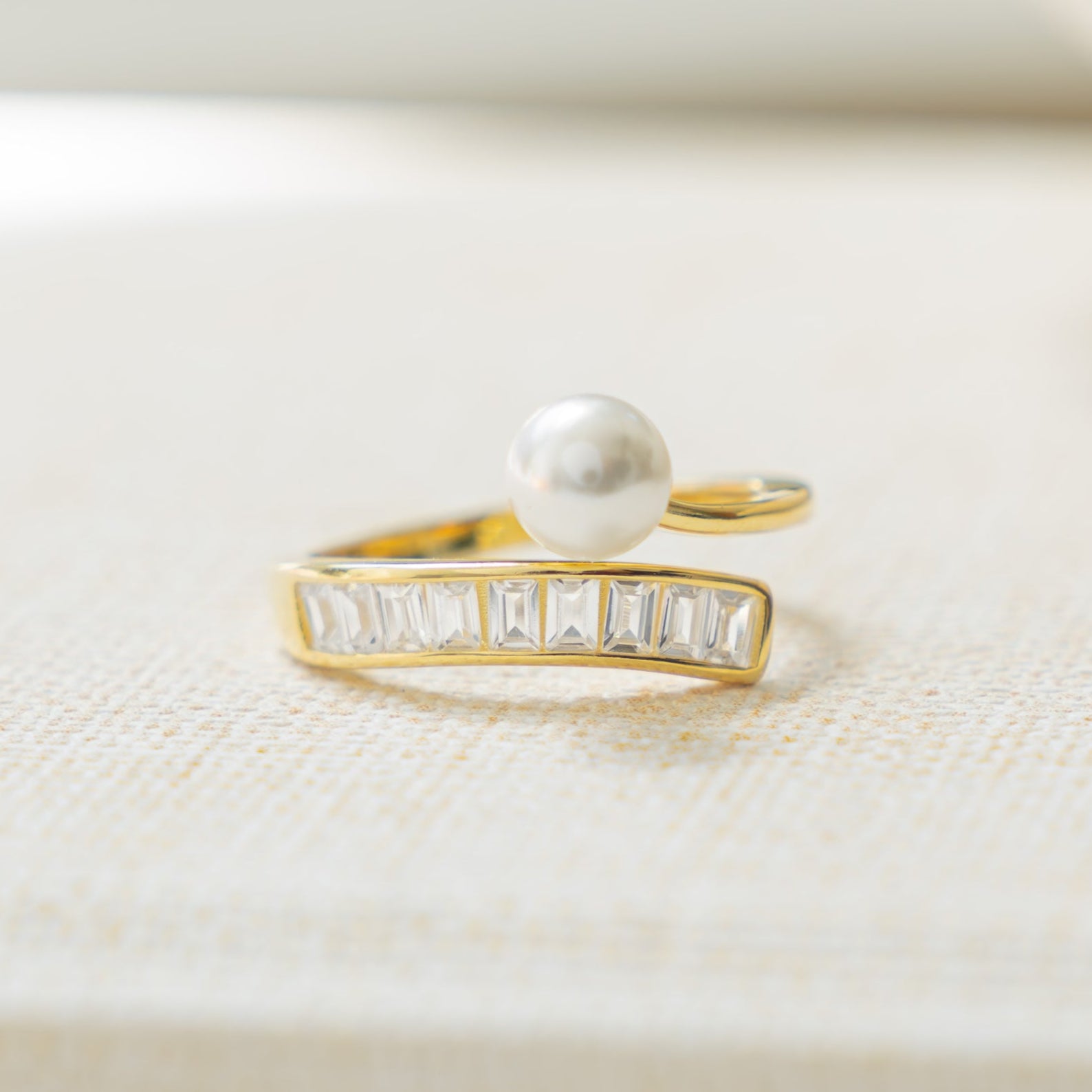 gold statement ring with wrap ring design and freshwater pearls