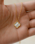 gold pendant necklace with a mother of pearl four leaf lucky clover pendant