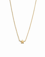 Gold star necklace on a white background