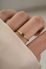 Gold peridot diamond stacking ring on model