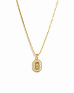 Gold personalized necklace with a custom pendant featuring the letter 'S' on a white background