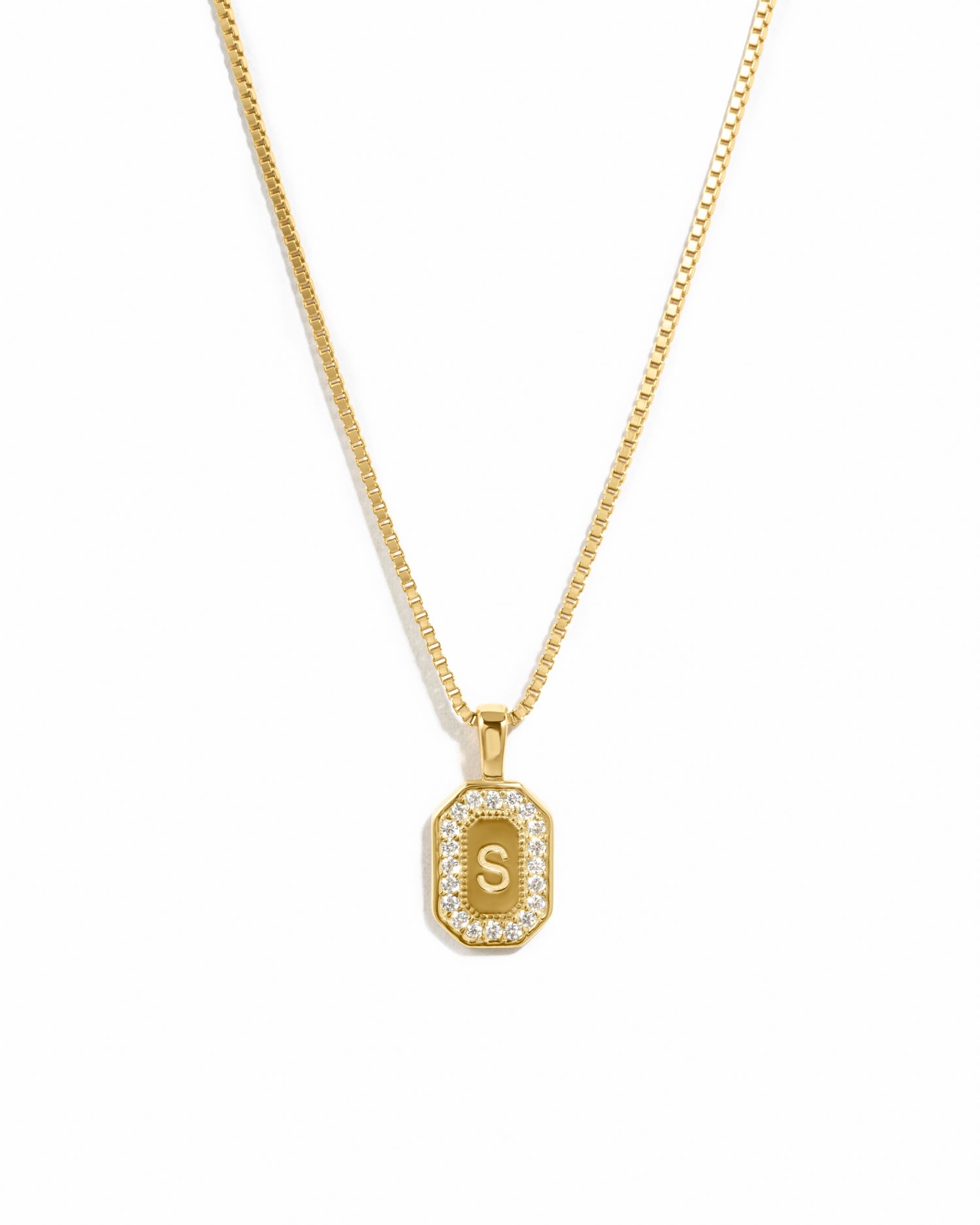 Gold personalized necklace with a custom pendant featuring the letter 'S' on a white background