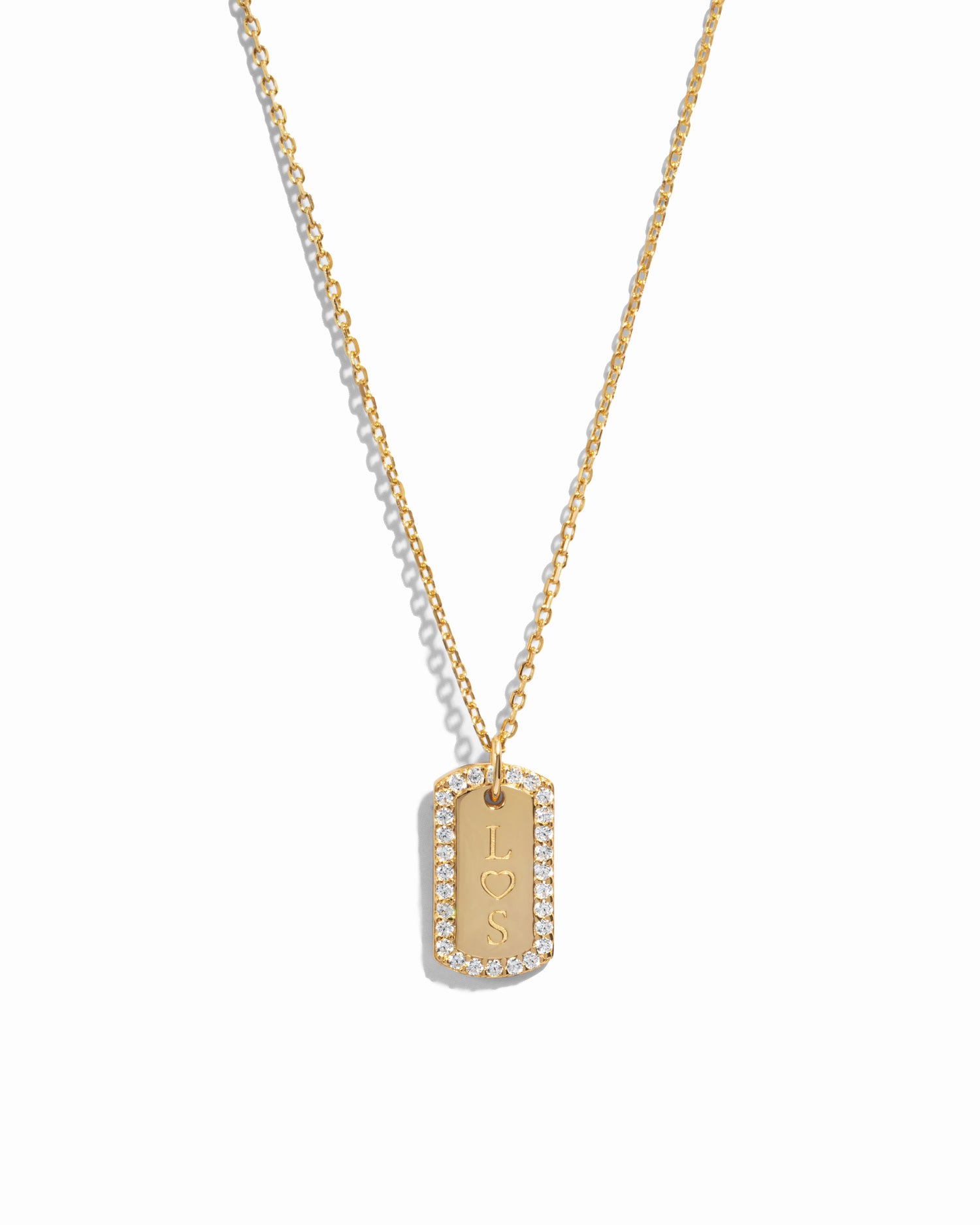 gold custom jewelry featuring a custom necklace with initials on pendant over a white background 