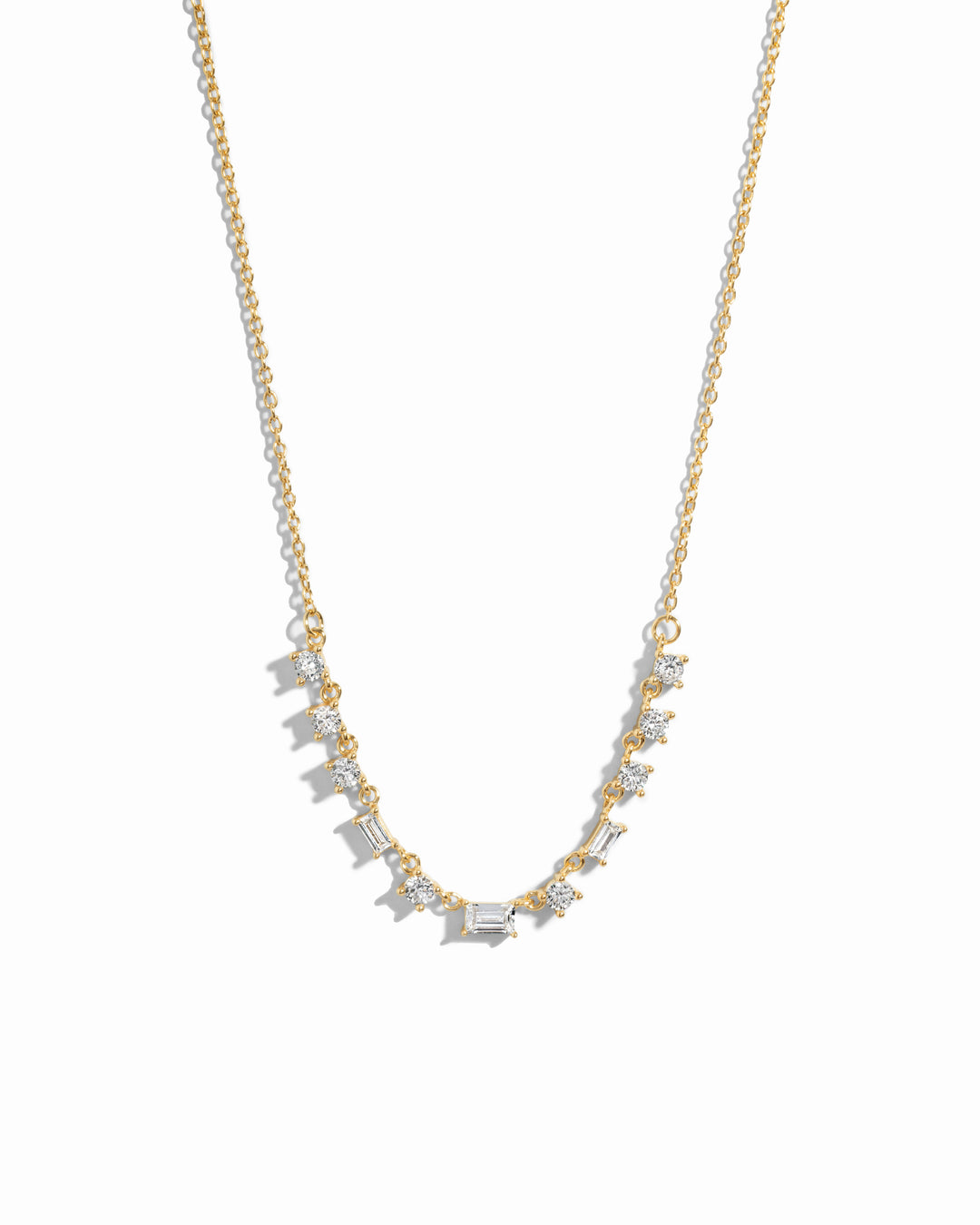 Closeup image of gold diamond baguette necklace on white background 