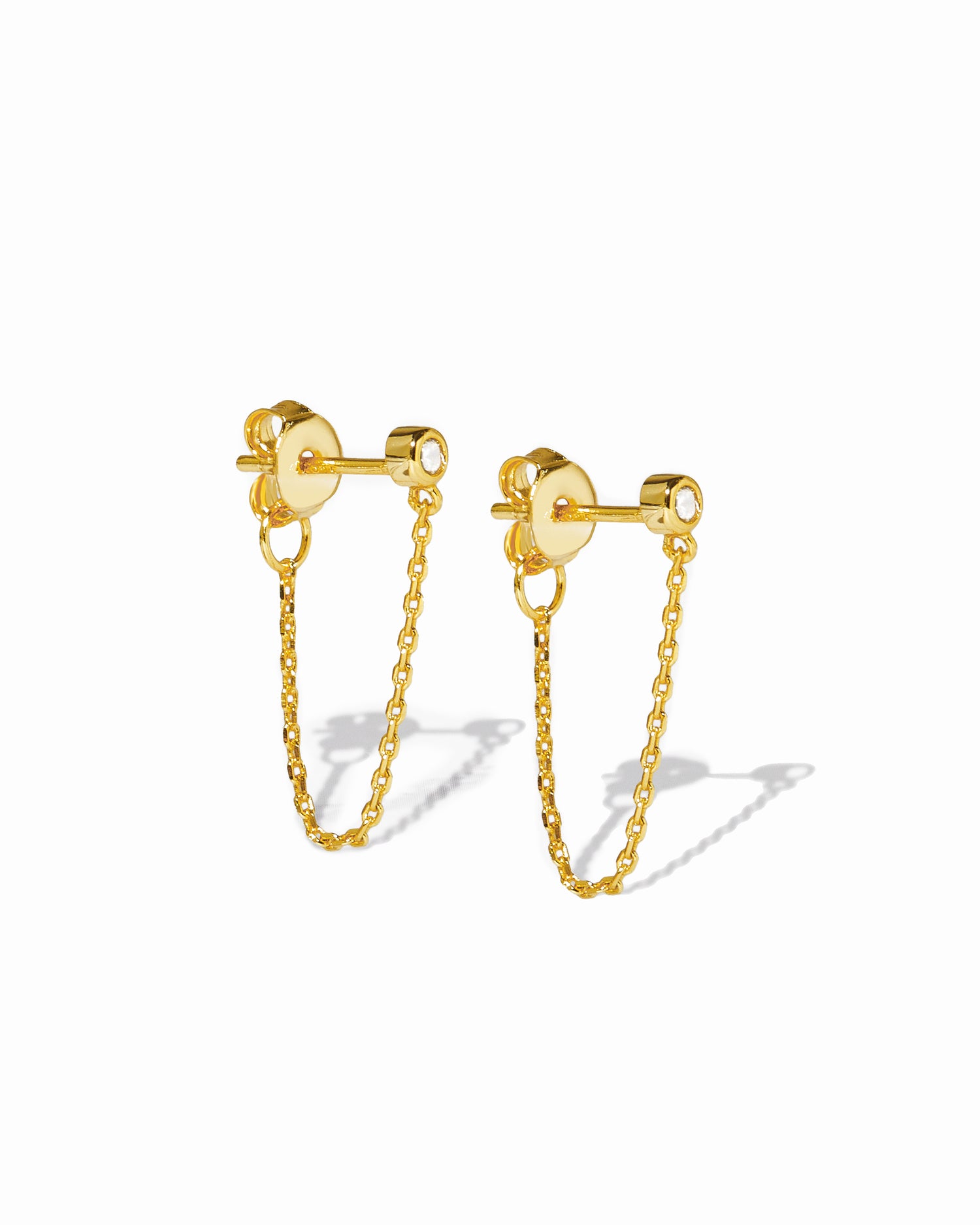 Gold chain stud earrings on a white background
