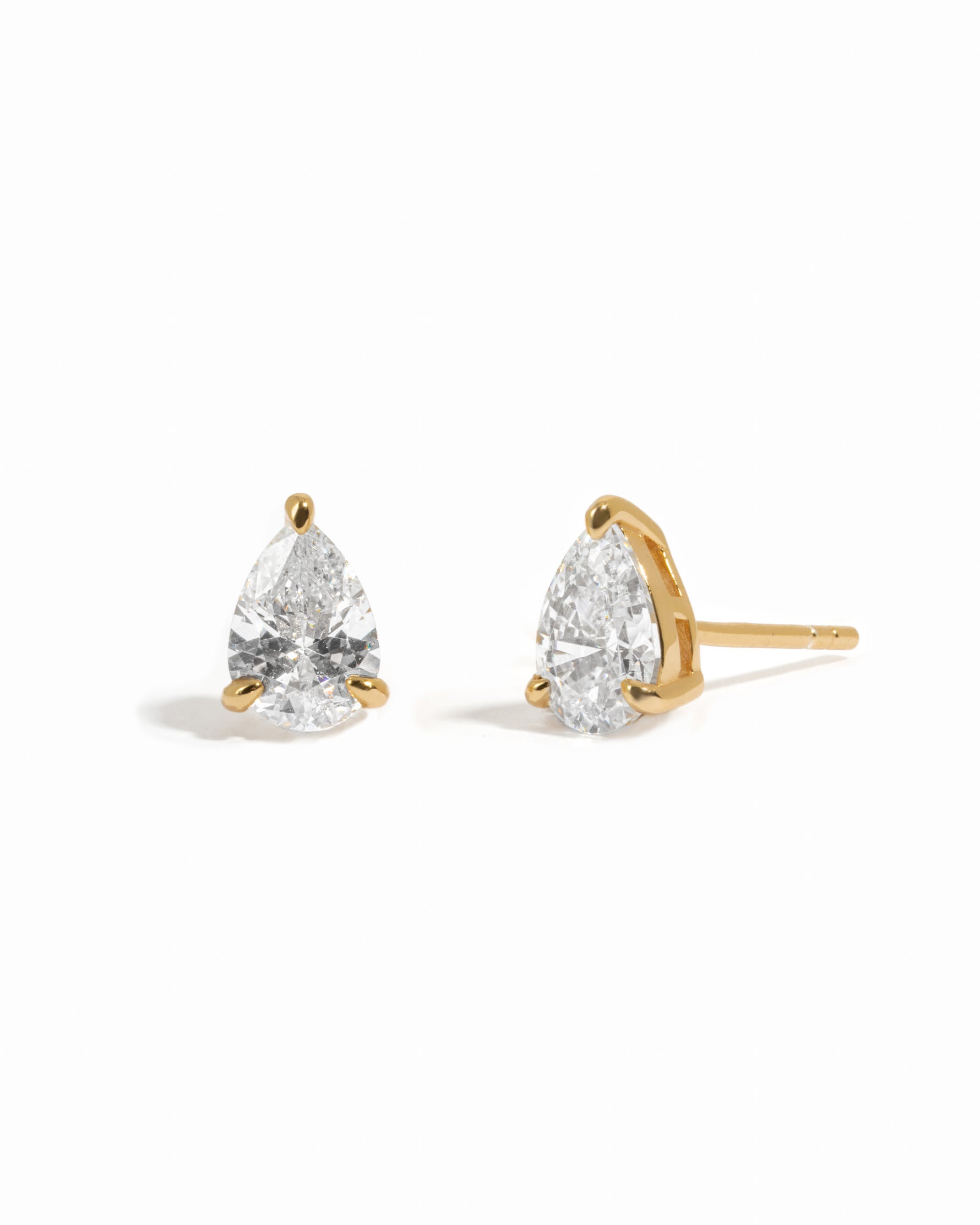 Pair of gold plated diamond stud earrings on a white background