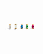 Set of five gold stud earrings with different colored birthstones on a white background featuring, white cz, opal, sapphire, emerald and ruby