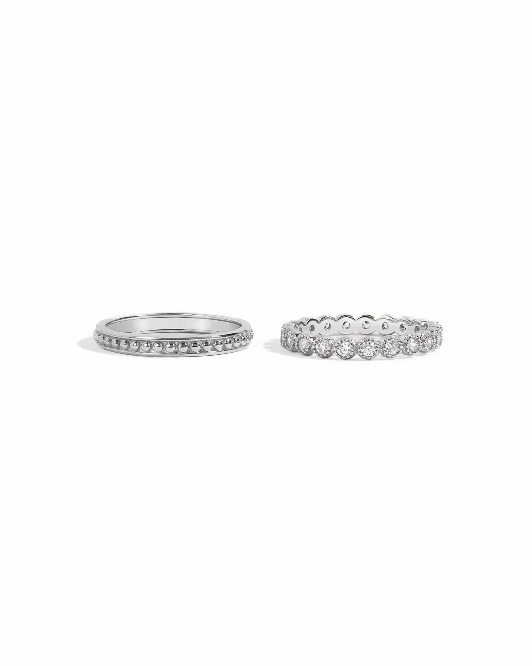 silver stacking ring set, one with a dainty beaded design and one with a studded bezel set cubic zirconia stone