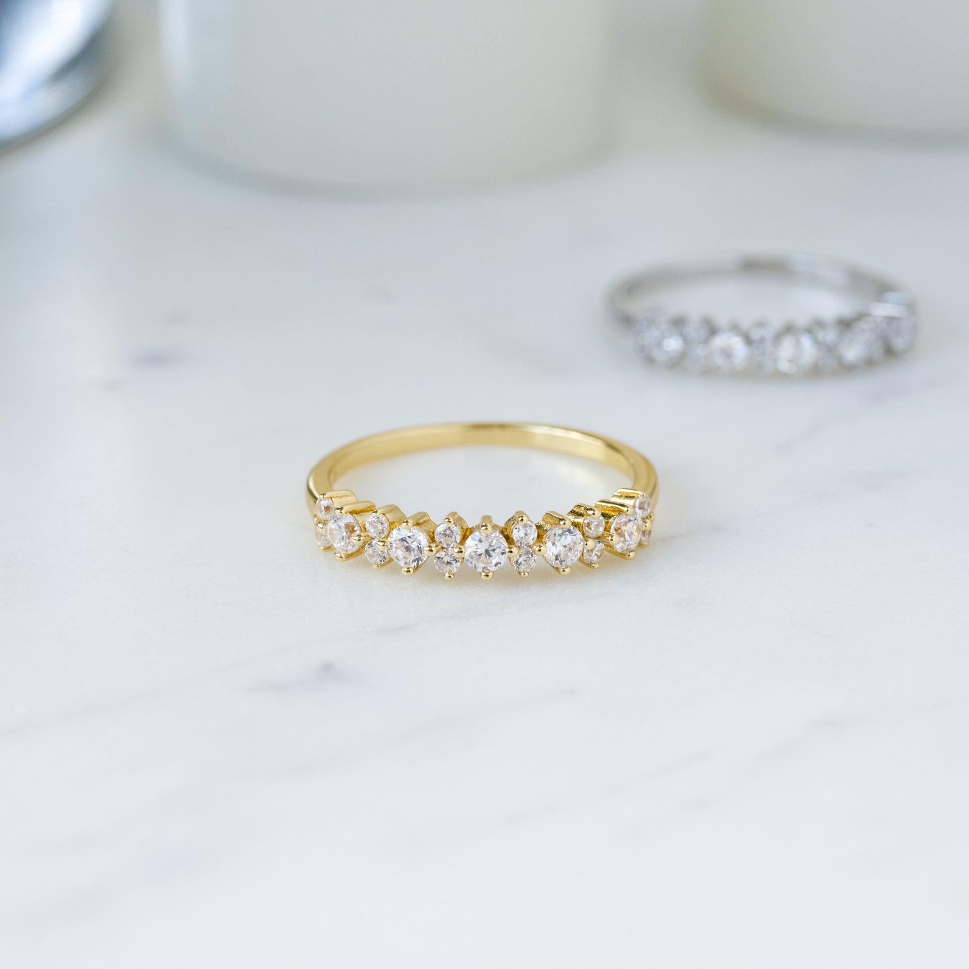 gold dainty ring with alternating diamond stones on it