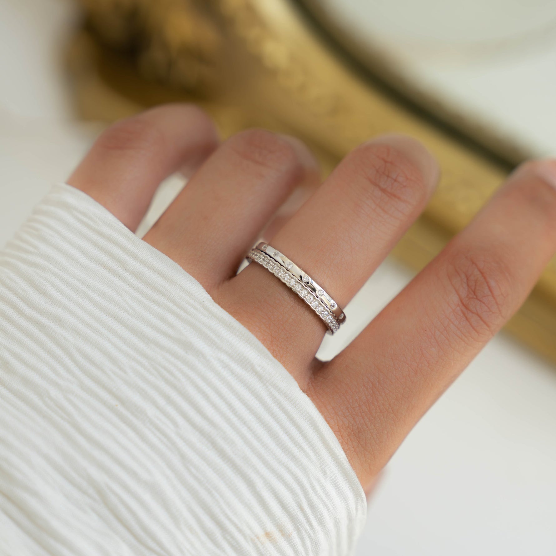 Model wearing silver bezel ring set 