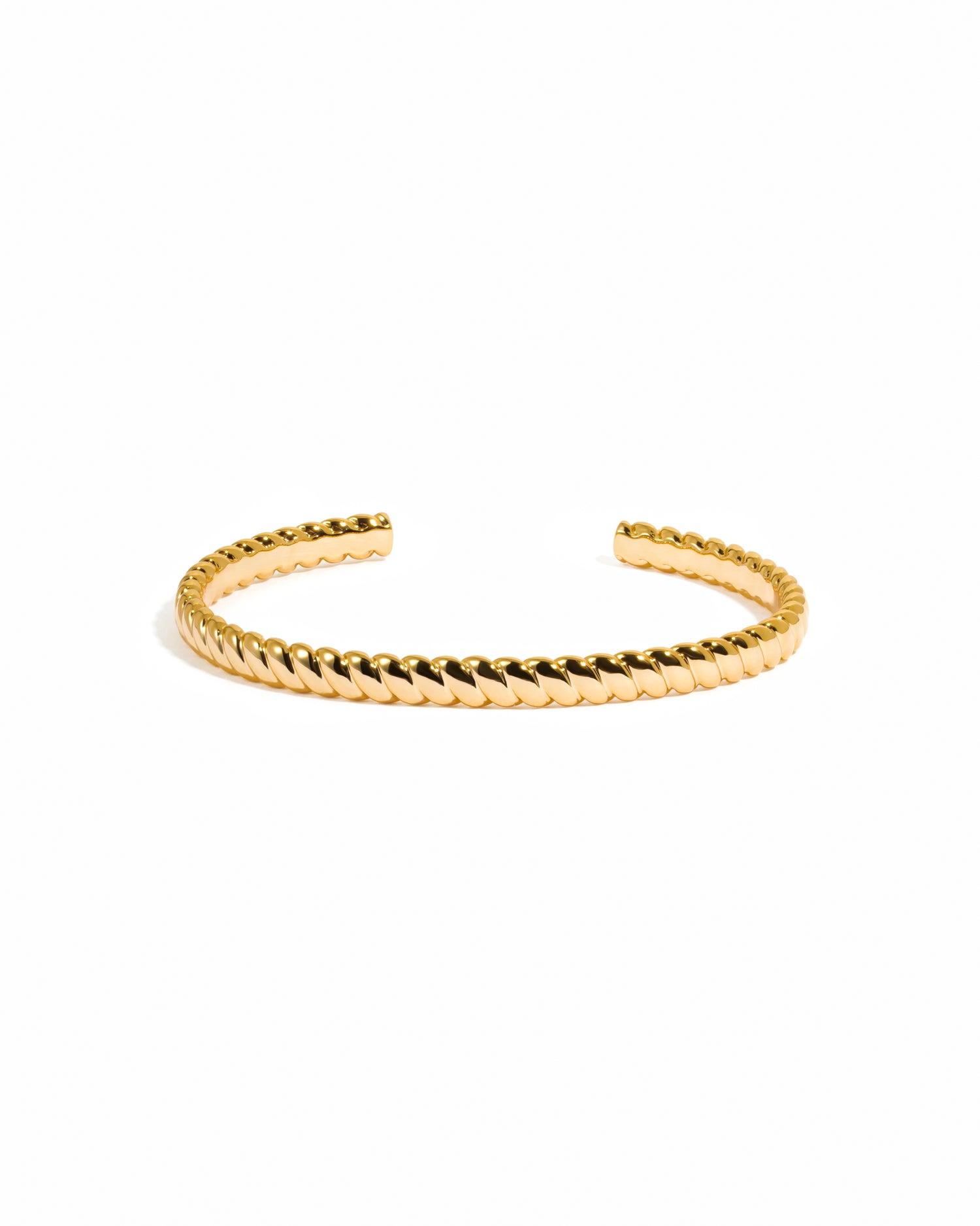 Gold spiral cuff bracelet on a white background