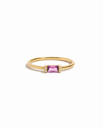 Gold ring with a pink gemstone on a white background