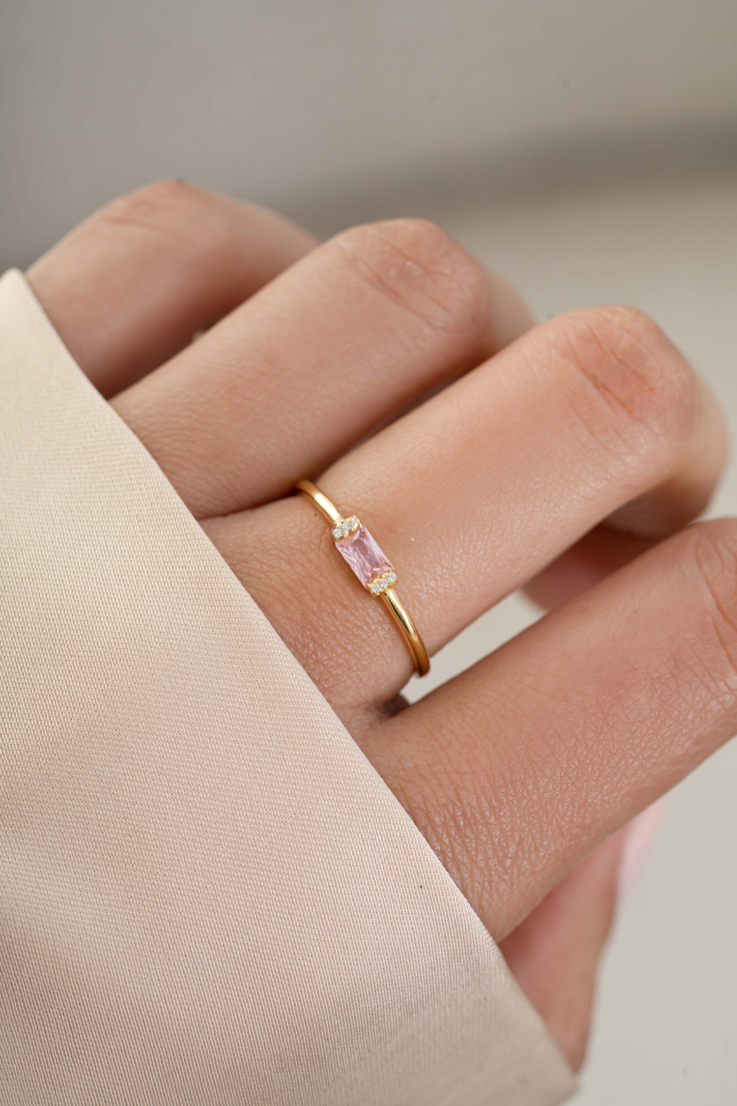 Gold rose October birthstone ring on model