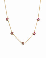 gold chain with five ruby birthstone flower pendants