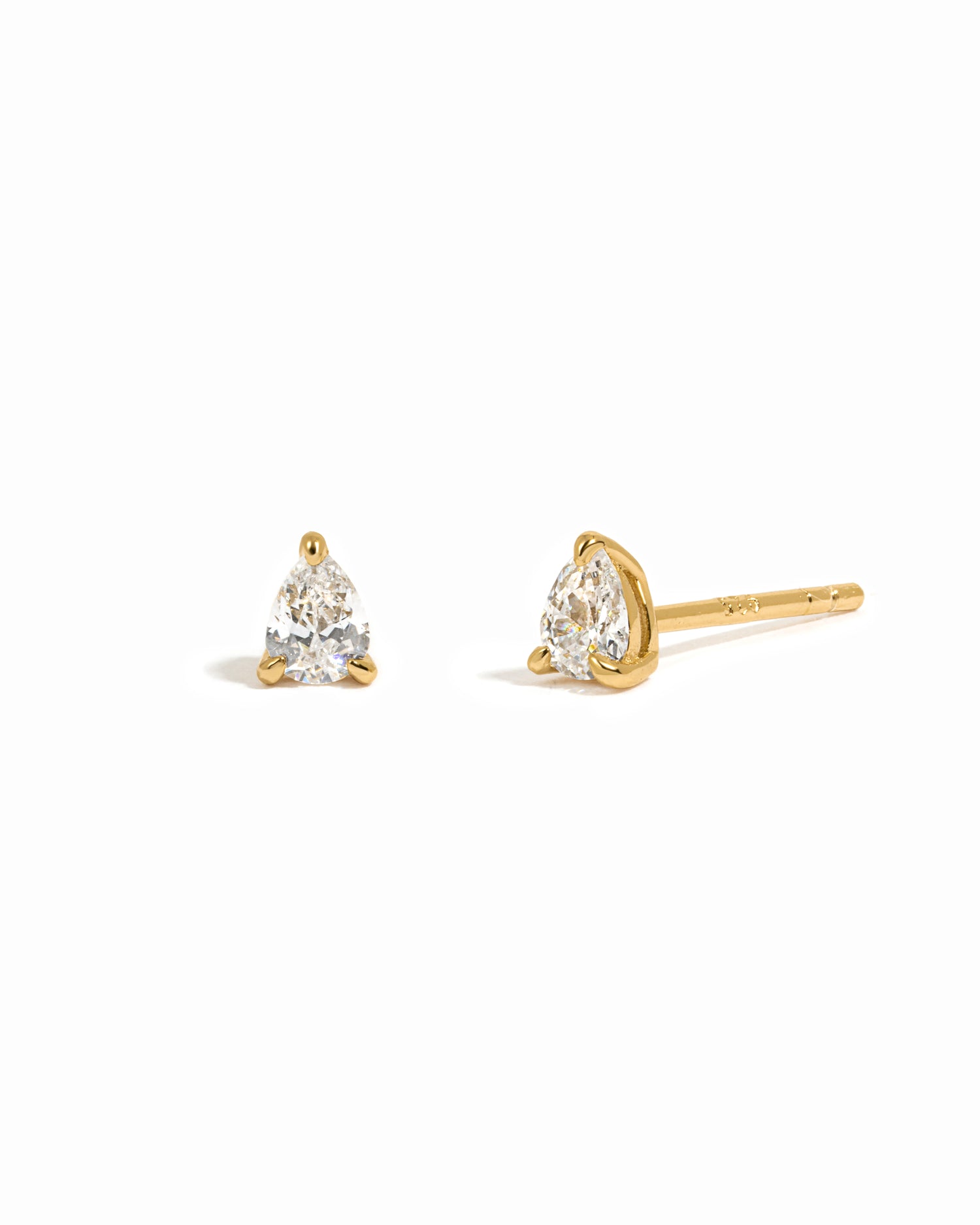 Pair of gold earring with cubic zirconia gemstones on a white background