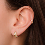 model wearing gold hoops featuring gold double hoop earrings