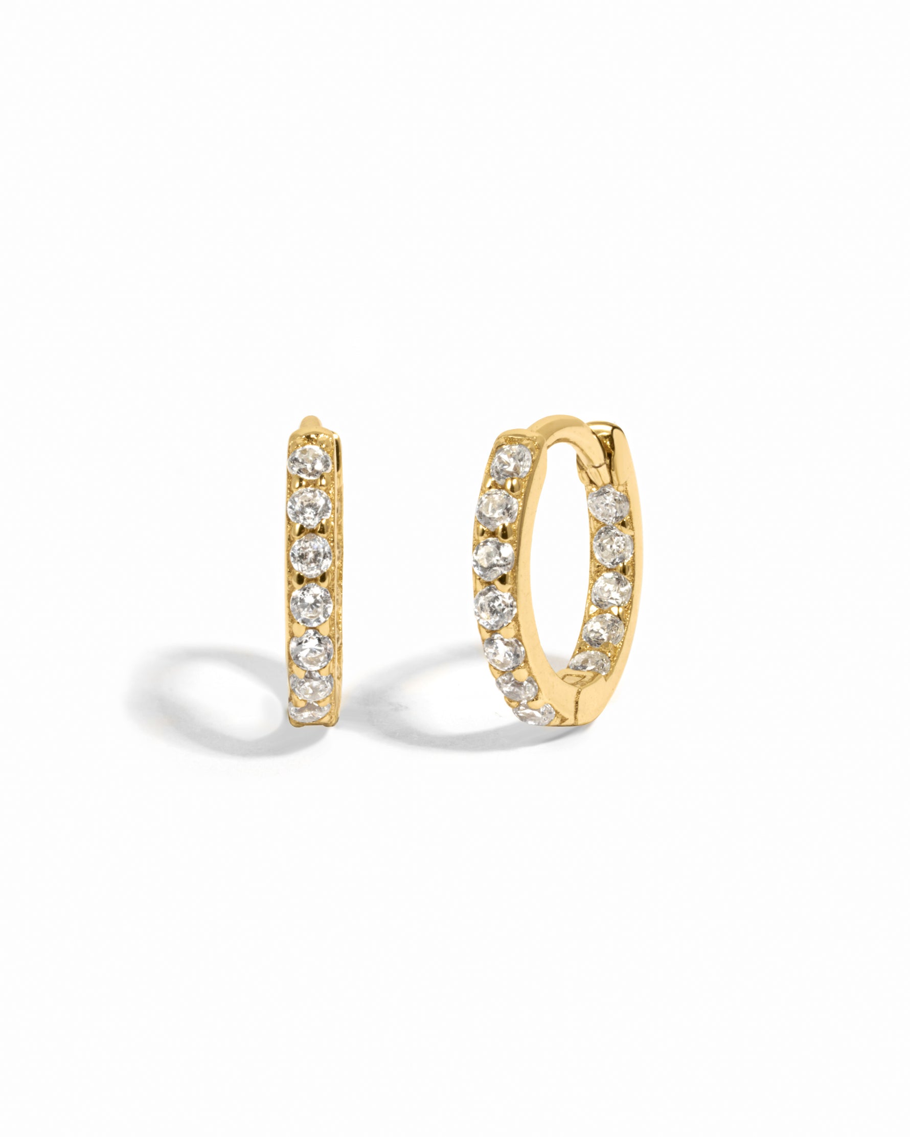 Gold mini hoops on a white background