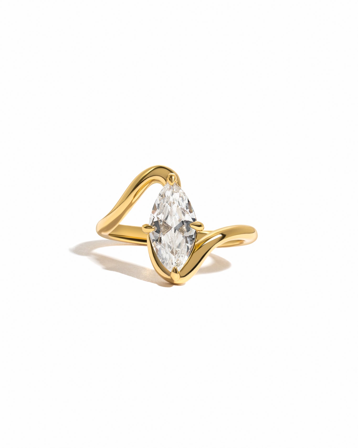 Gold marquise ring on white background