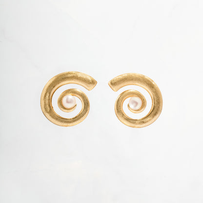 closeup image of gold and pearl earrings