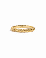 Gold ring with intricate spiral design on a white background