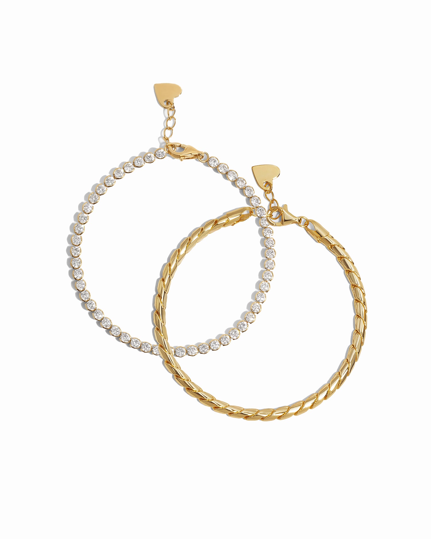 Gold tennis bracelet and a gold chain chunky bracelet on a white background