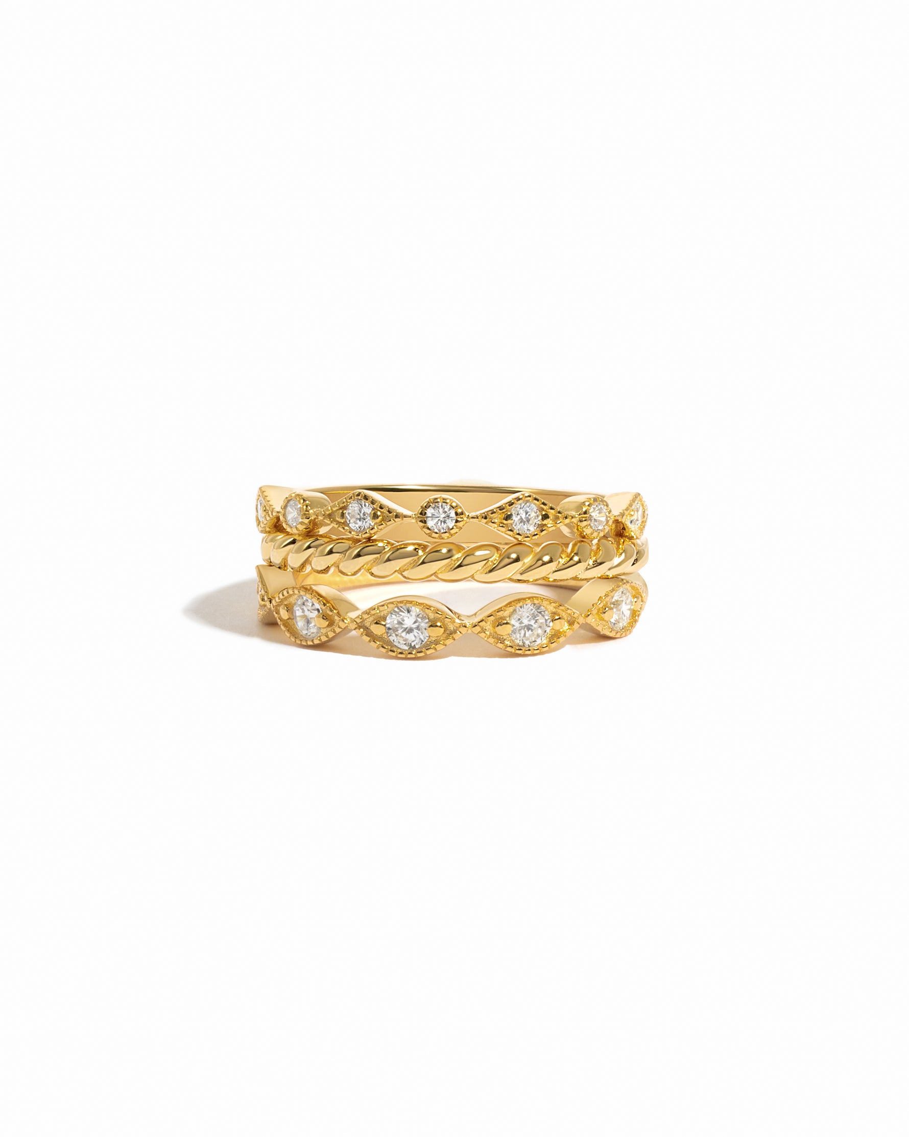Three gold plated stacking rings on a white background