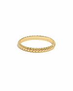 Gold ring with a textured band on a white background