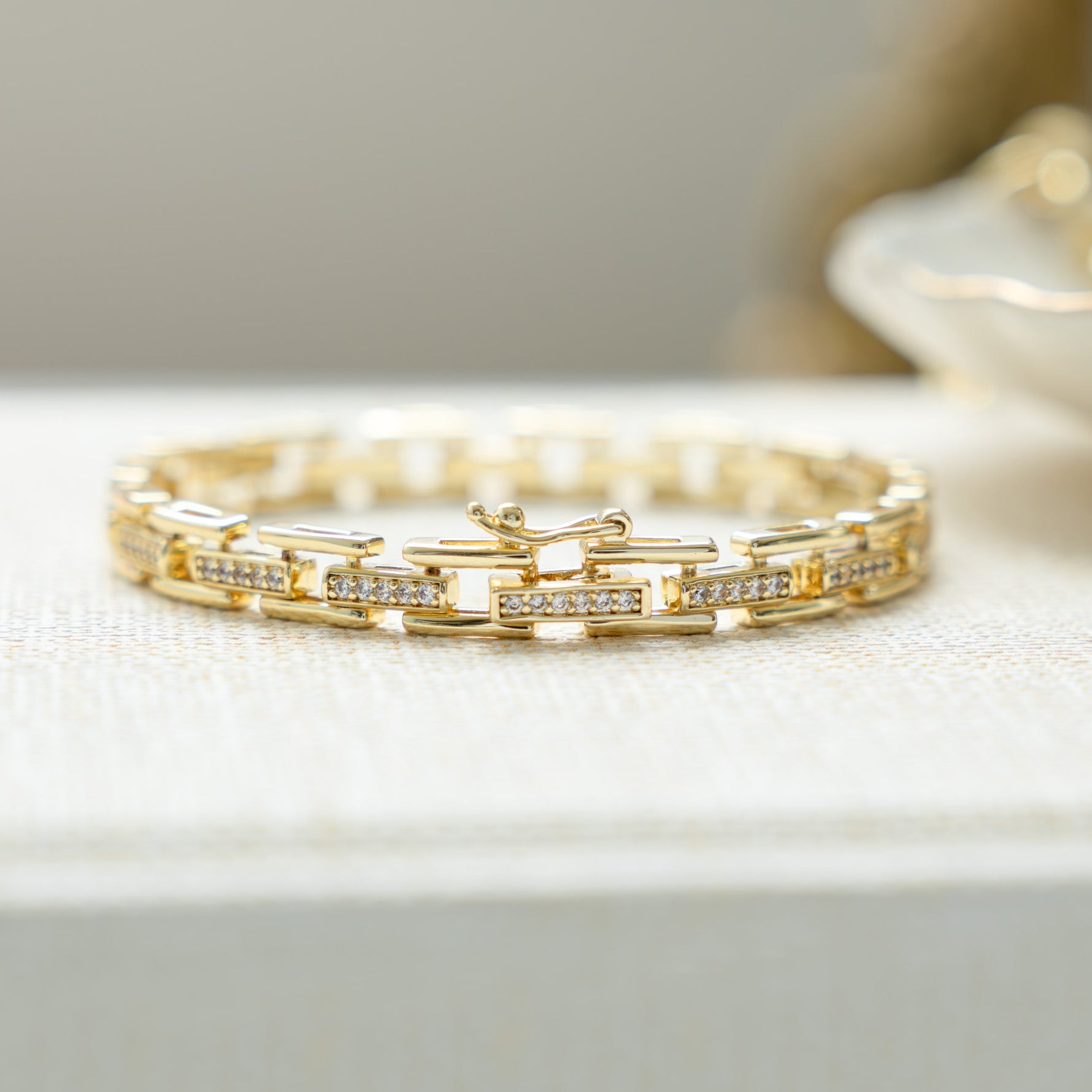 Closeup view of unique jewelry featuring a chunky gold chain link bracelet