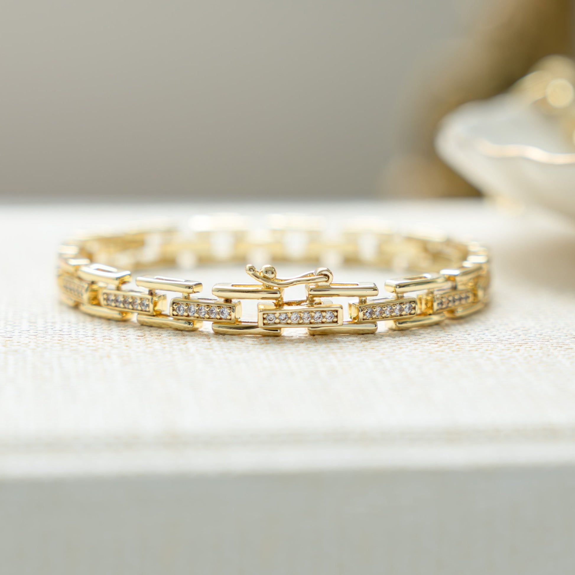 Closeup view of unique jewelry featuring a chunky gold chain link bracelet