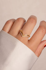 Model wearing dainty gold chevron ring set. 
