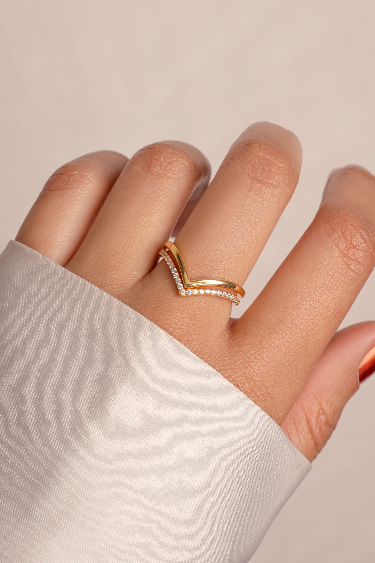 Model wearing dainty gold chevron ring set. 