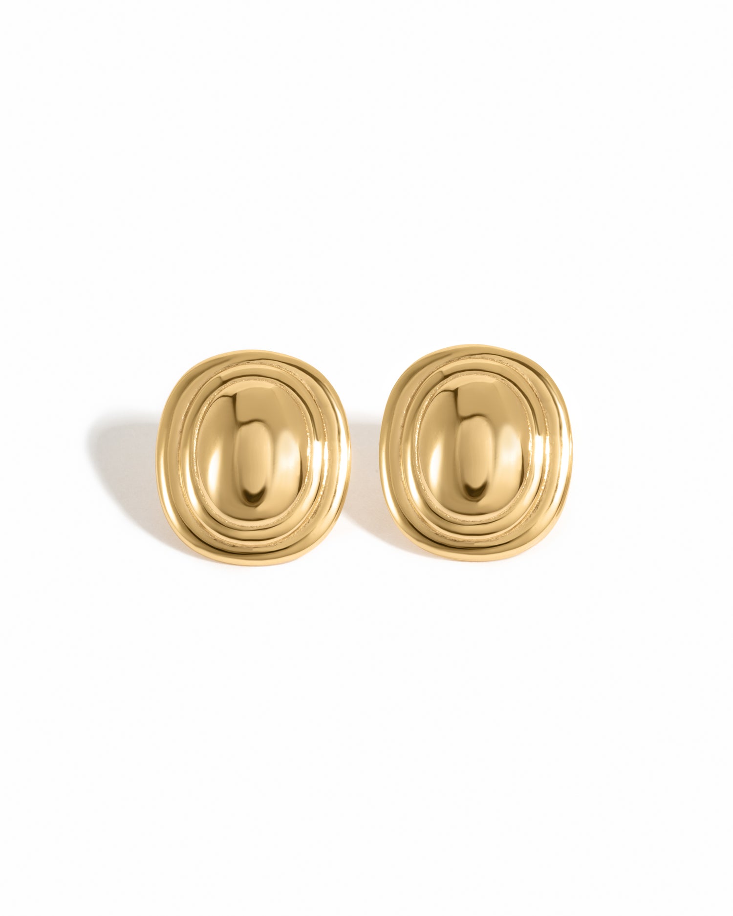 A pair of gold stud earrings